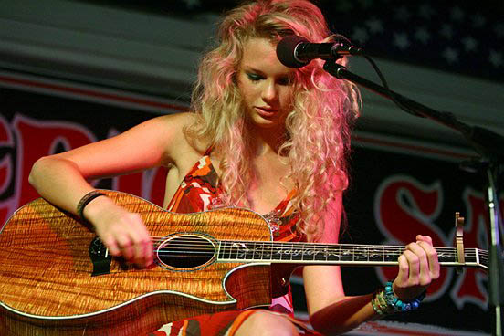 Taylor Swift playing the guitar to who audience; photo by Dwight McCann